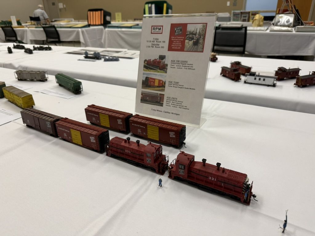 Atlantic Great Eastern locomotives and boxcars with clinic sign