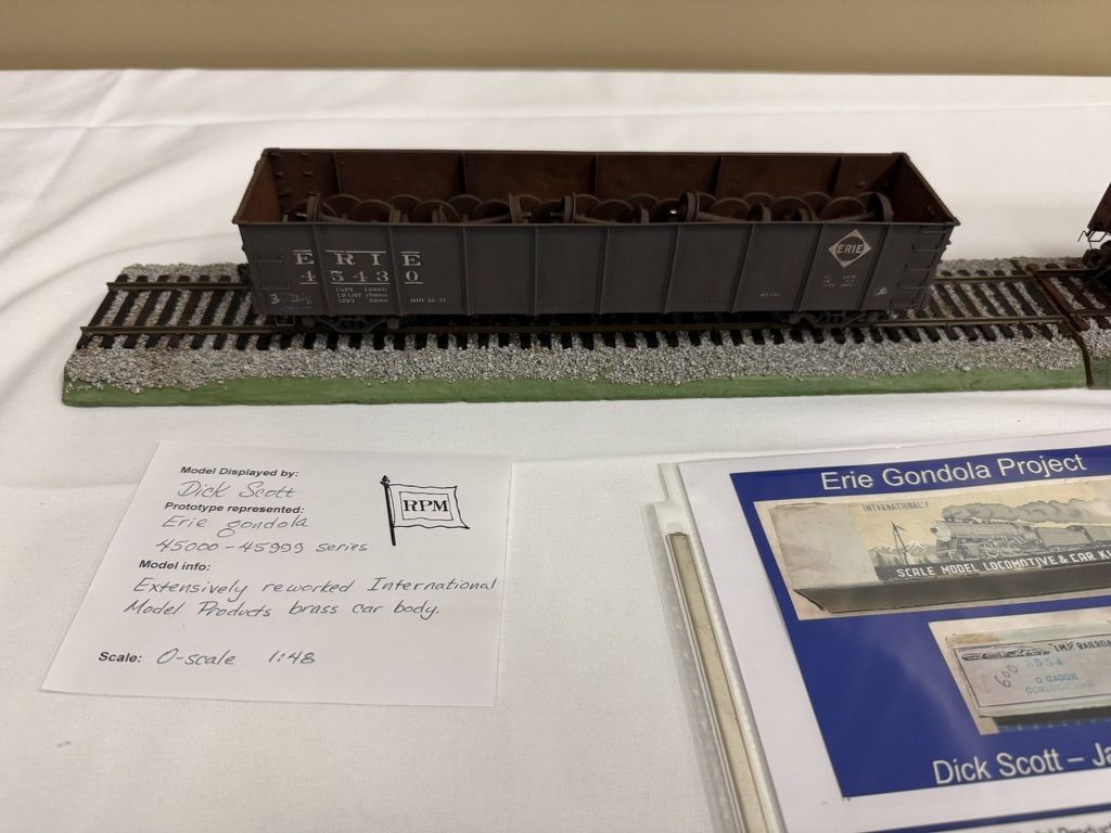 O-scale Erie gondola on display track with model card