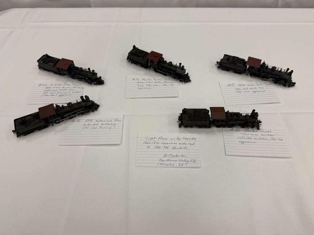 Five small steam locomotives with handwritten cards