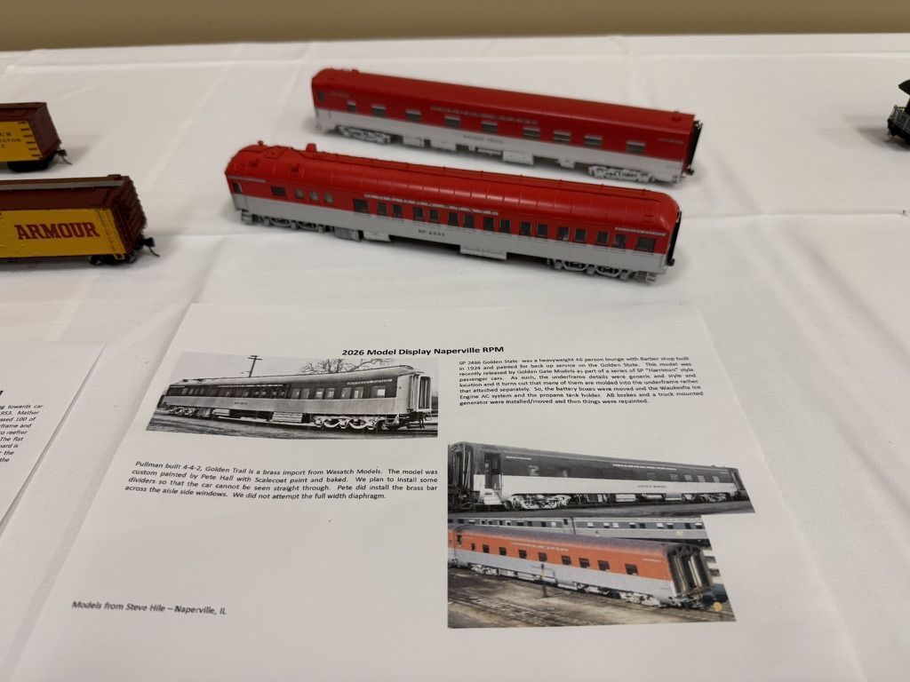 Two red passenger cars with display sheet